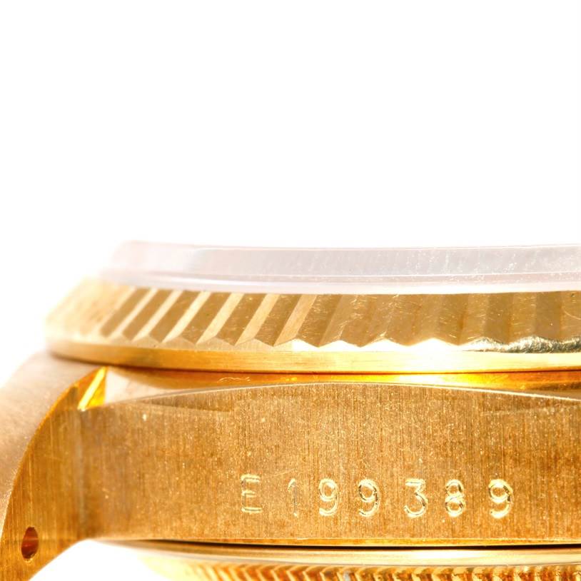 This image shows a close-up angle of the case side, bezel, and serial number of a Rolex President 18238 Men's Yellow Gold Beige Dial 18238 Men's Yellow Gold Beige Dial model watch.