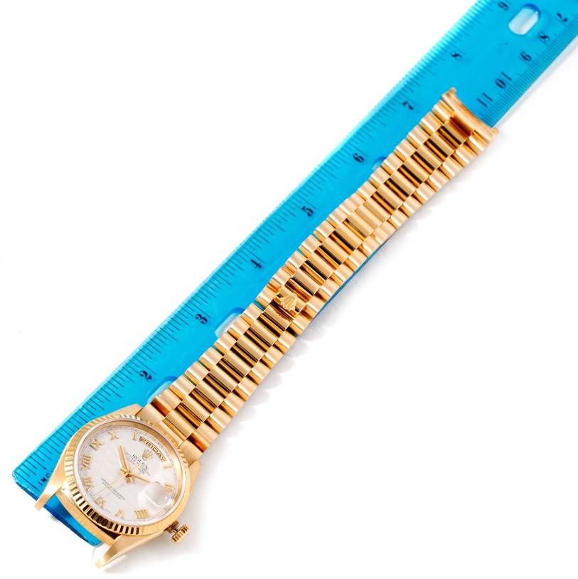 The image shows a Rolex President 18238 Men's Yellow Gold Beige Dial 18238 Men's Yellow Gold Beige Dial model watch at an overhead angle, with the face and bracelet next to a blue ruler.