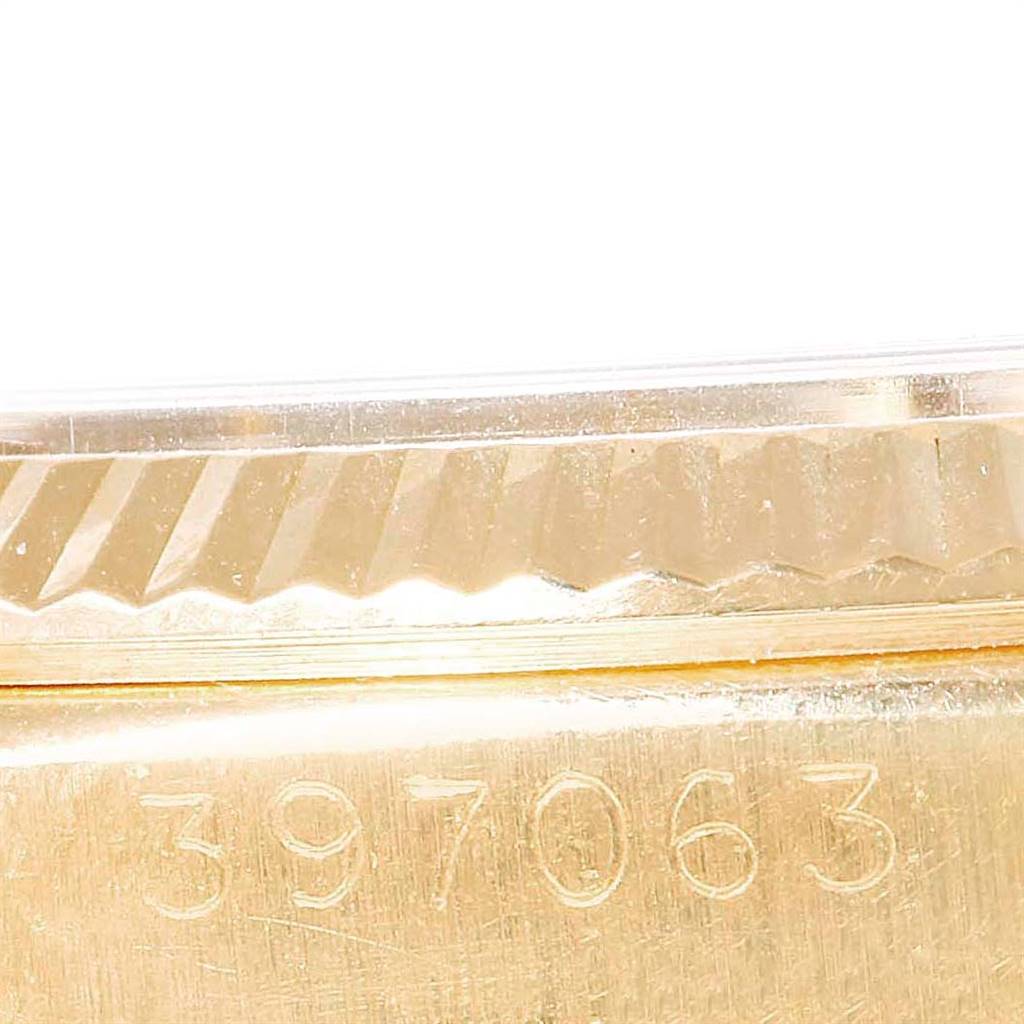 This image shows a close-up of the serial number engraving and fluted bezel of the Rolex President 6611 Men's Yellow Gold Champagne Dial 6611 Men's Yellow Gold Champagne Dial model watch.