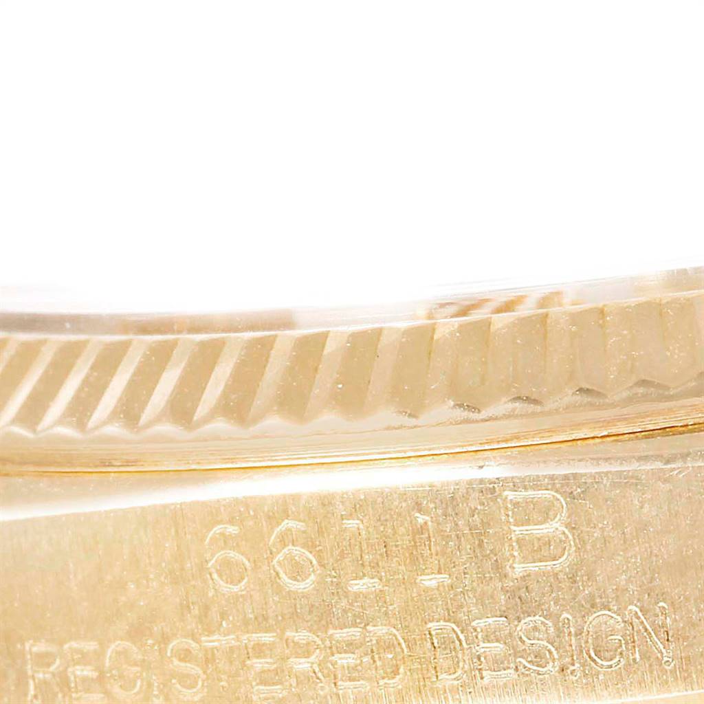 The image shows a close-up of the side of a Rolex President 6611 Men's Yellow Gold Champagne Dial 6611 Men's Yellow Gold Champagne Dial model, highlighting the fluted bezel and part of the case with engraved text.