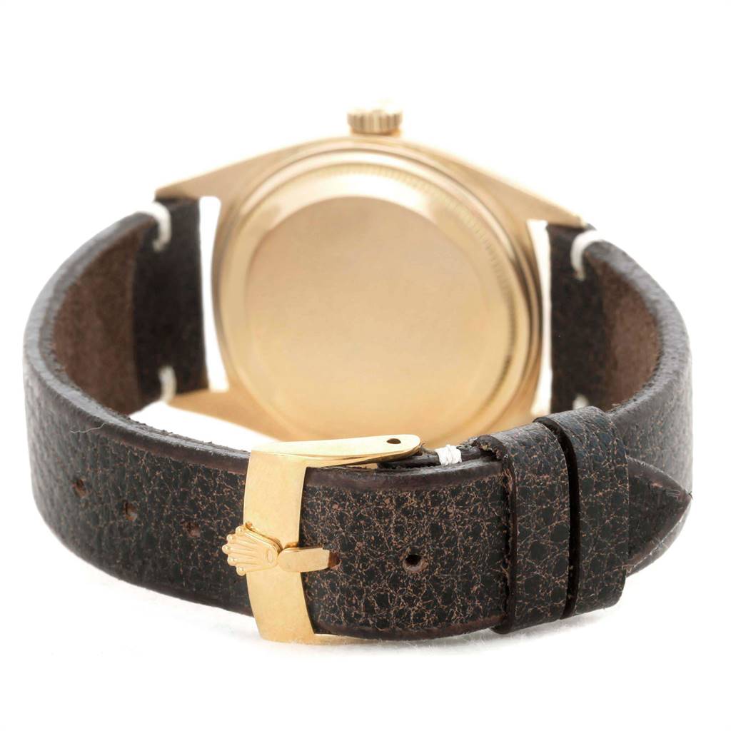 This image shows the back case and clasp of the Rolex President 6611 Men's Yellow Gold Champagne Dial 6611 Men's Yellow Gold Champagne Dial model watch with a leather strap.