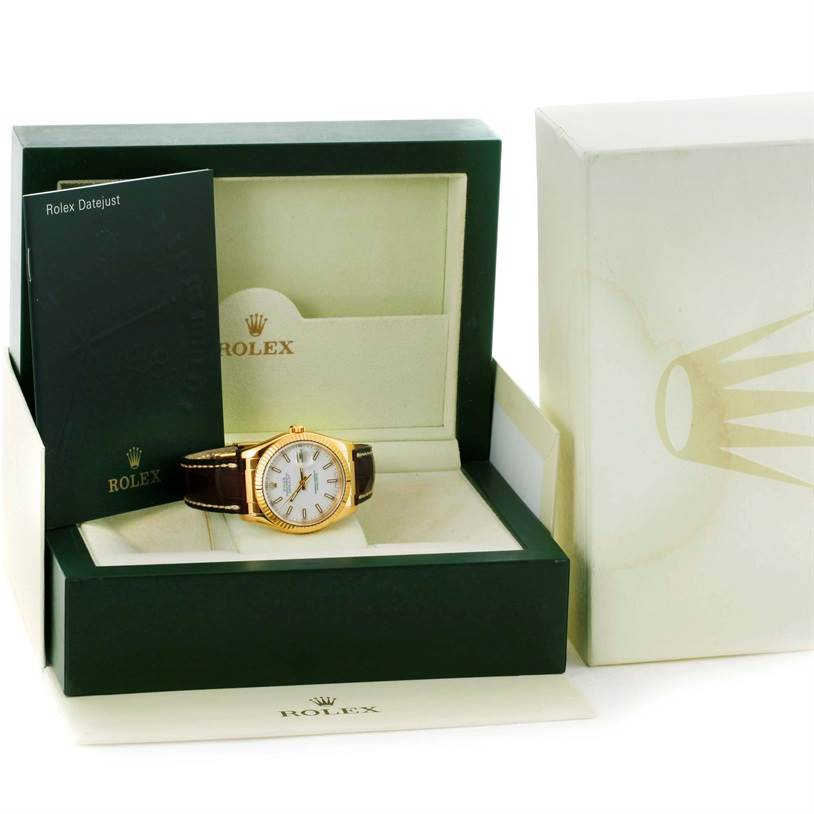 This image shows a Rolex President 116138 Men's Yellow Gold White Dial 116138 Men's Yellow Gold White Dial watch in its open box, alongside the packaging and a booklet.