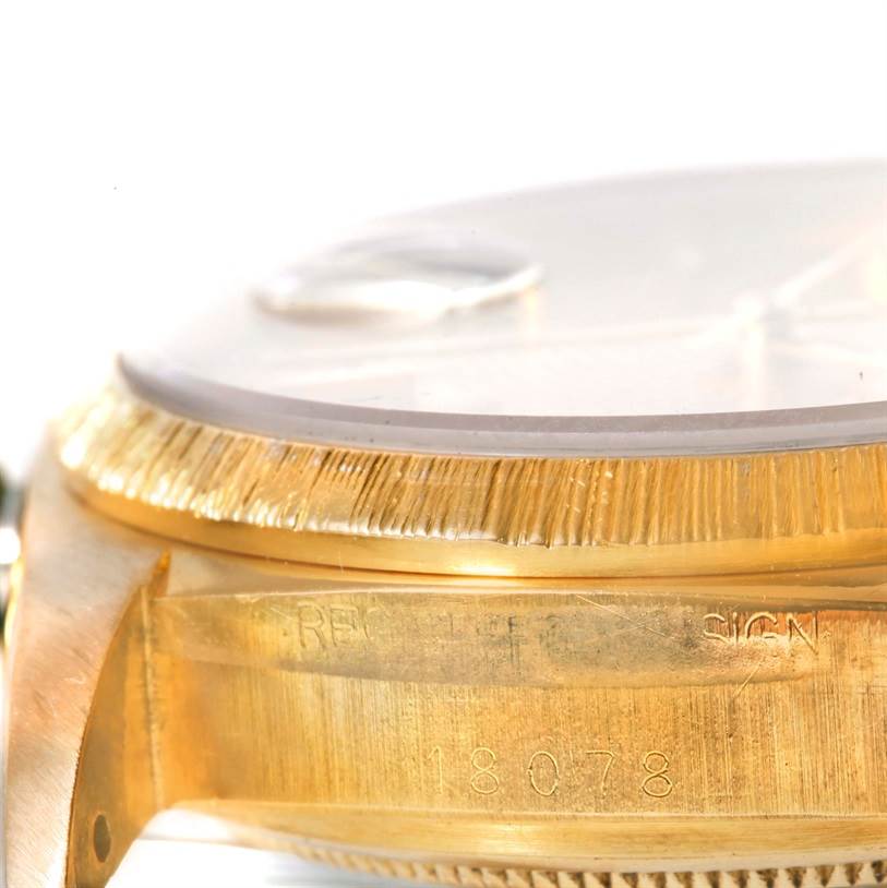 This close-up angle shows the side view of the Rolex President 18078 Yellow Gold Champagne Dial 18078 Yellow Gold Champagne Dial model watch, highlighting its bezel and part of the case with engravings.