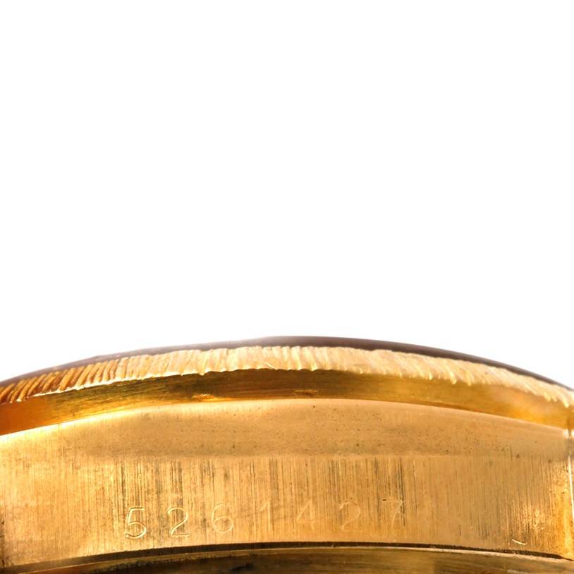 This is a close-up view of the side of the Rolex President 18078 Yellow Gold Champagne Dial 18078 Yellow Gold Champagne Dial model, showing the case with engraved serial numbers.