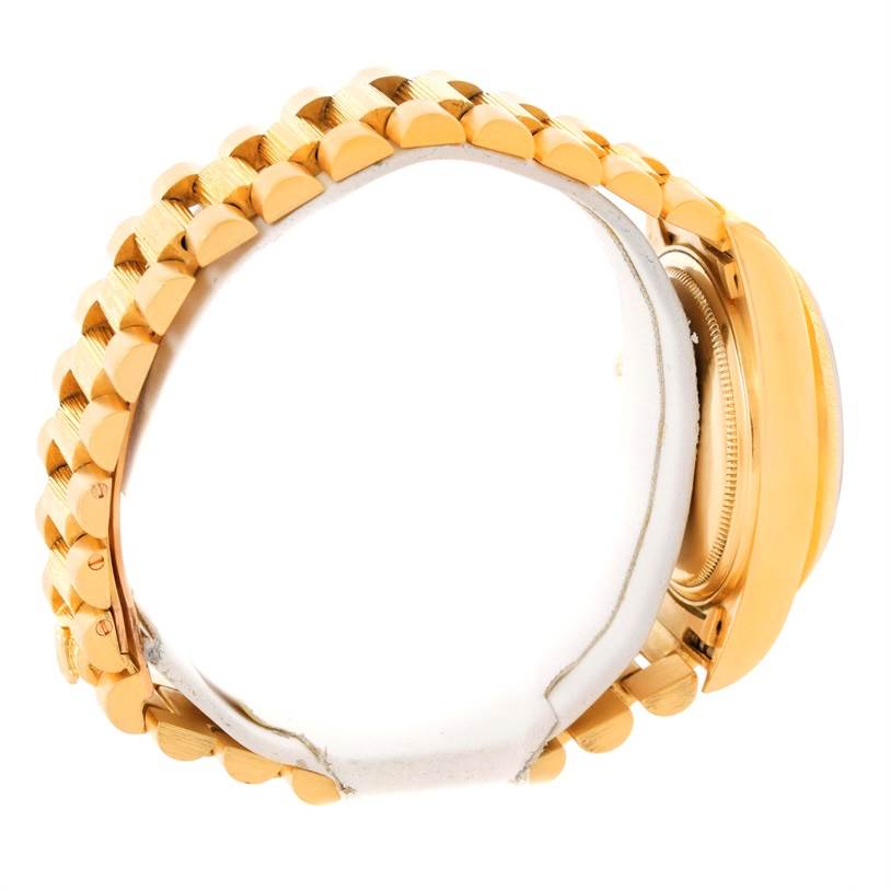 The image shows a side view of a Rolex President 18078 Yellow Gold Champagne Dial 18078 Yellow Gold Champagne Dial model, highlighting the gold bracelet and the case back.