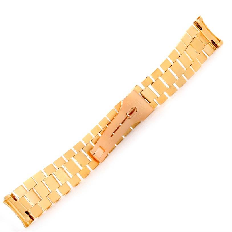This image shows a gold bracelet for the Rolex President   model watch, viewed from above.