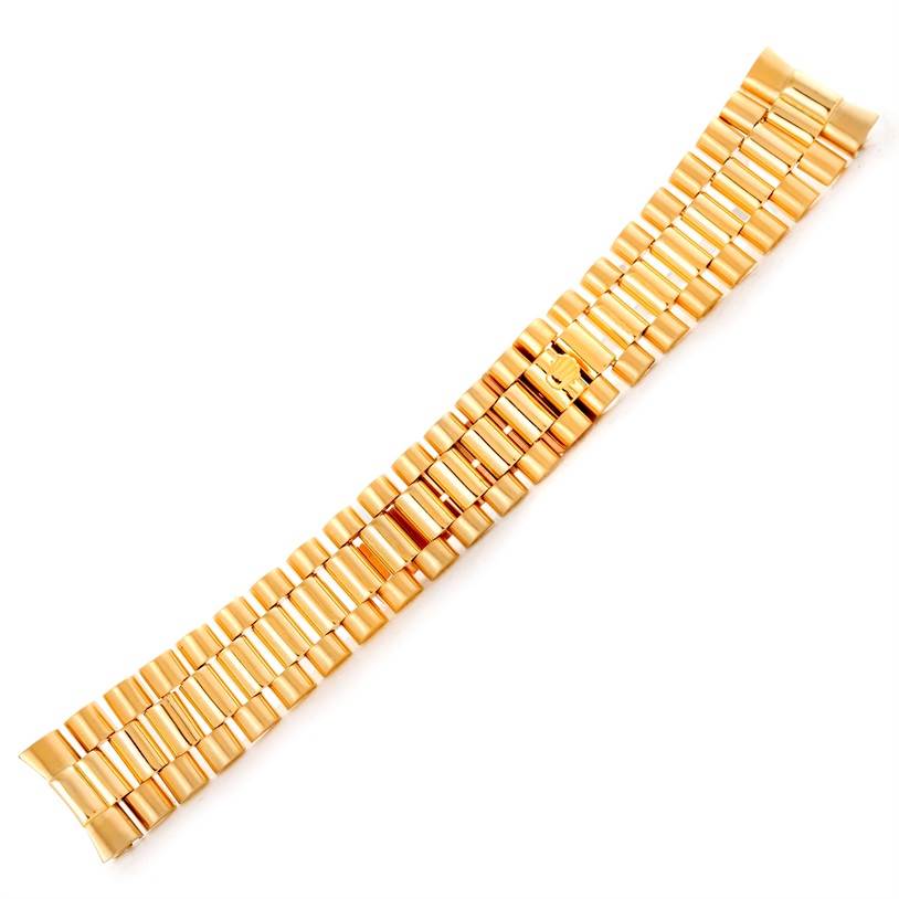 This image shows a gold bracelet strap for the Rolex President   model, viewed from above.