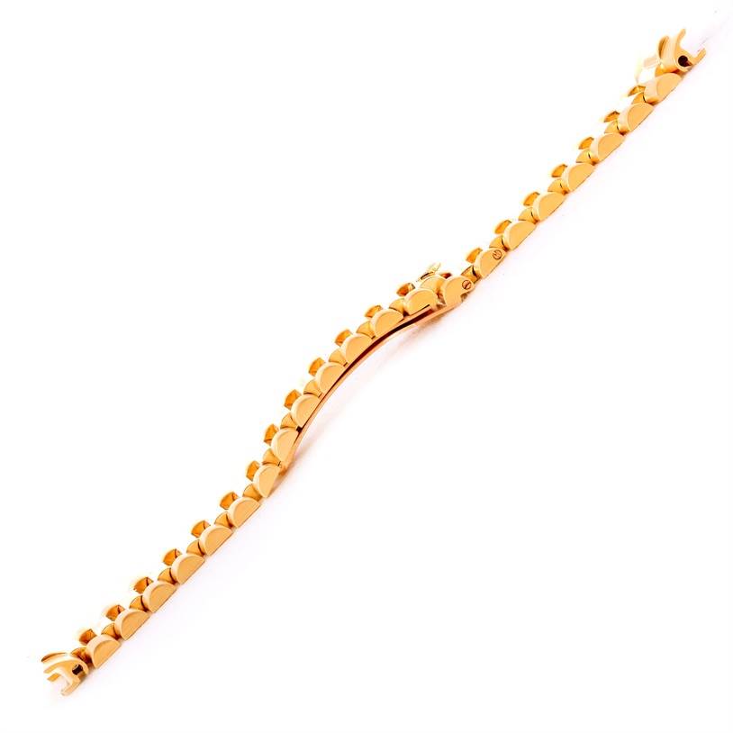 This image shows a gold President bracelet for a Rolex watch, viewed from a top-down angle.