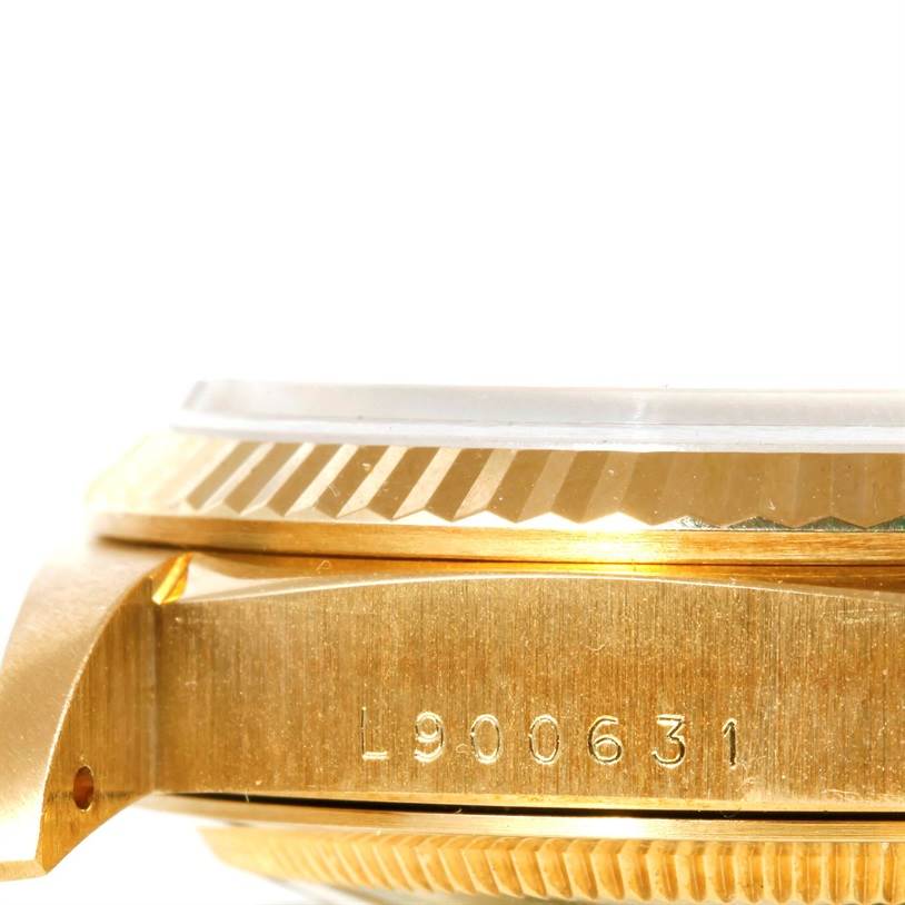 This image shows a close-up side view of the case and bezel of a Rolex President 18238 Men
s Yellow Gold Champagne Dial 18238 Men
s Yellow Gold Champagne Dial model watch, highlighting its serial number.