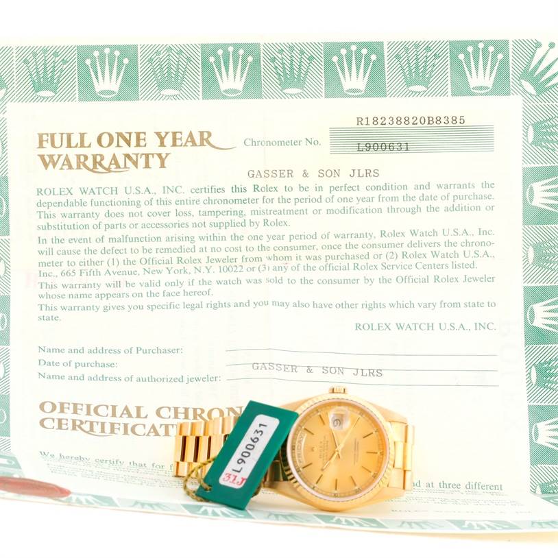 The image shows a Rolex President 18238 Men
s Yellow Gold Champagne Dial 18238 Men
s Yellow Gold Champagne Dial model watch next to its warranty card with both items photographed from above.