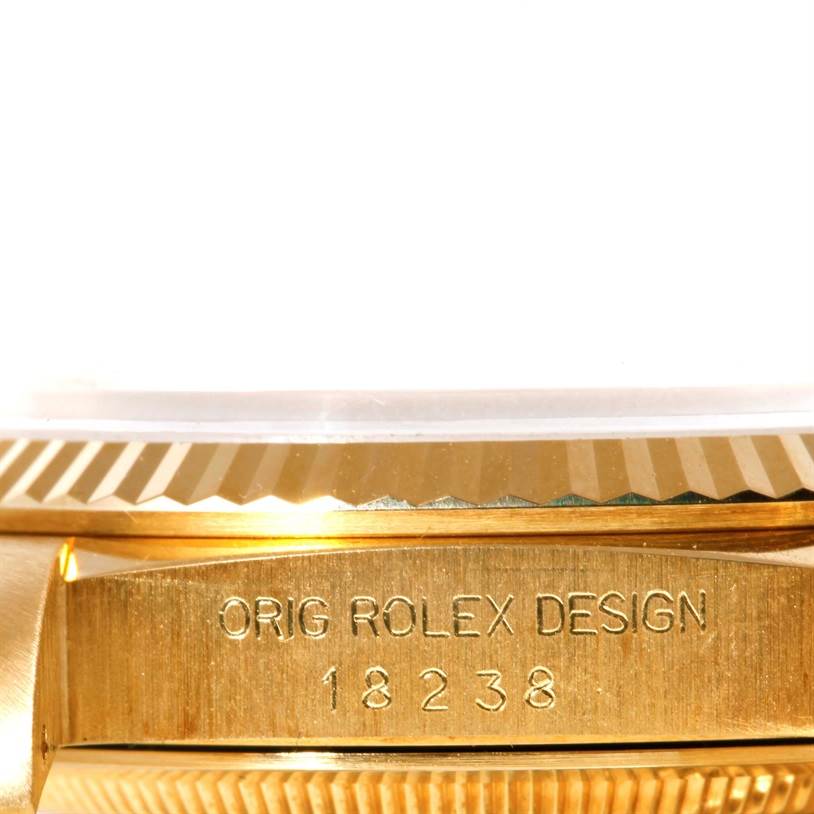 This image shows a detail of the side engraving and bezel of a Rolex President 18238 Men
s Yellow Gold Champagne Dial 18238 Men
s Yellow Gold Champagne Dial model watch.