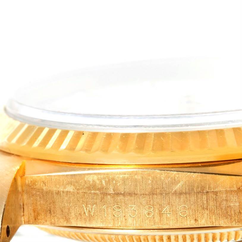 This image shows the side view of the case and bezel of a Rolex President 18238 Men's Yellow Gold White Dial 18238 Men's Yellow Gold White Dial watch, displaying the serial number.