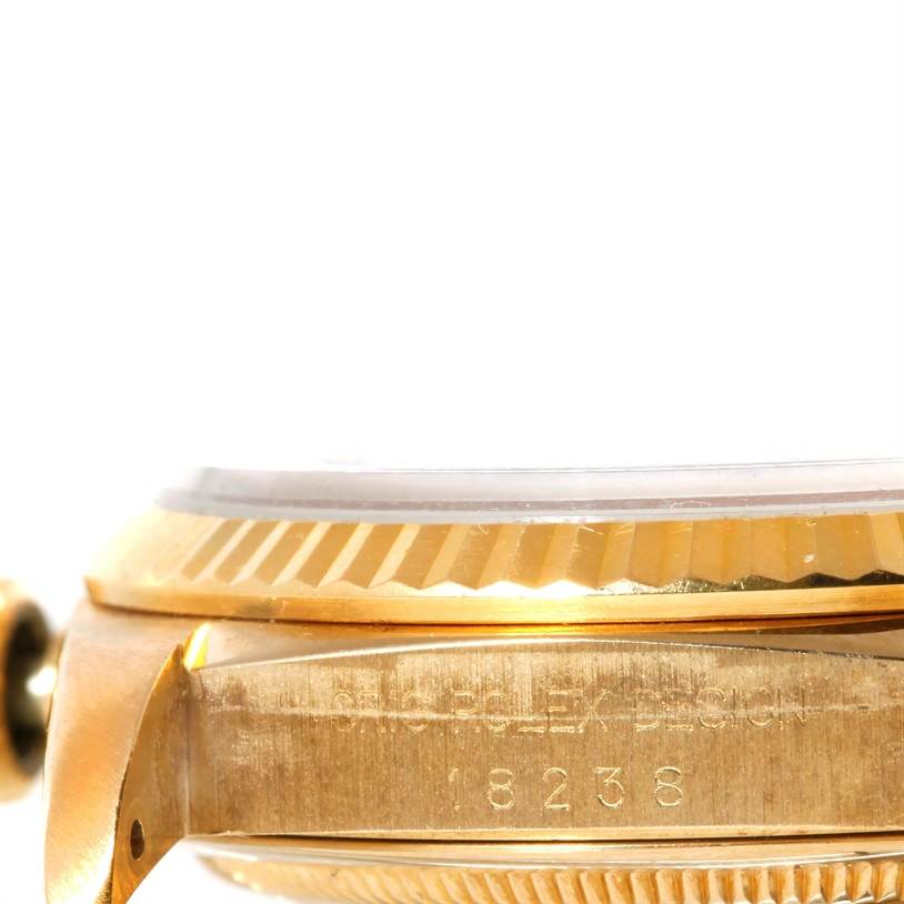 The image shows a close-up side view of the case and bezel, highlighting engravings on the Rolex President 18238 Men's Yellow Gold White Dial 18238 Men's Yellow Gold White Dial model watch.