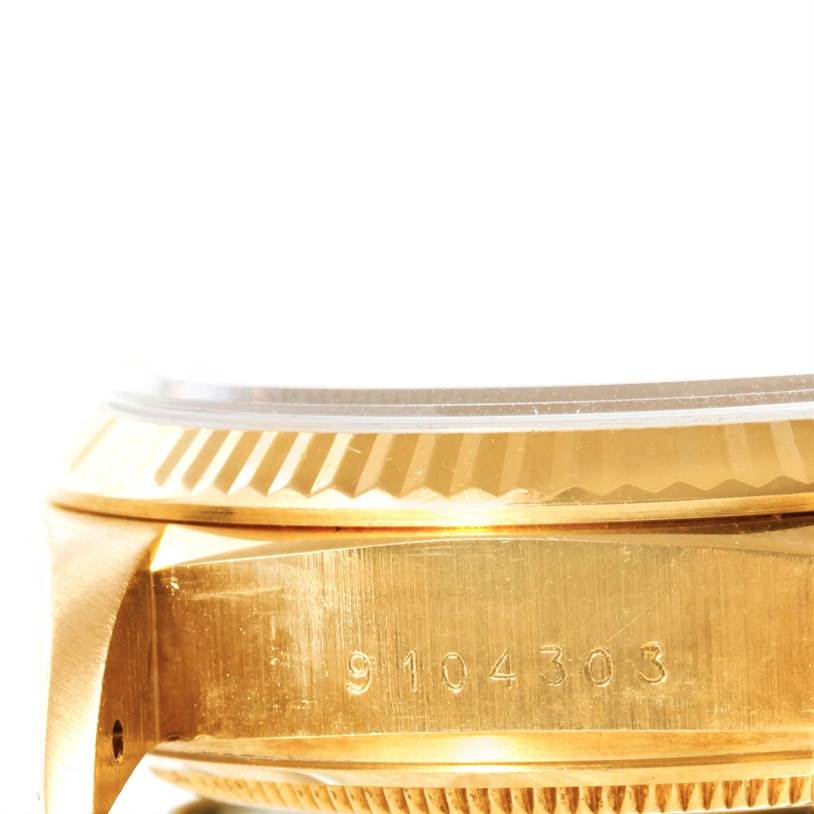 The image shows the side view of a Rolex President 18038 Men's Yellow Gold Black Dial 18038 Men's Yellow Gold Black Dial model watch, highlighting the bezel and case with engraved serial numbers.