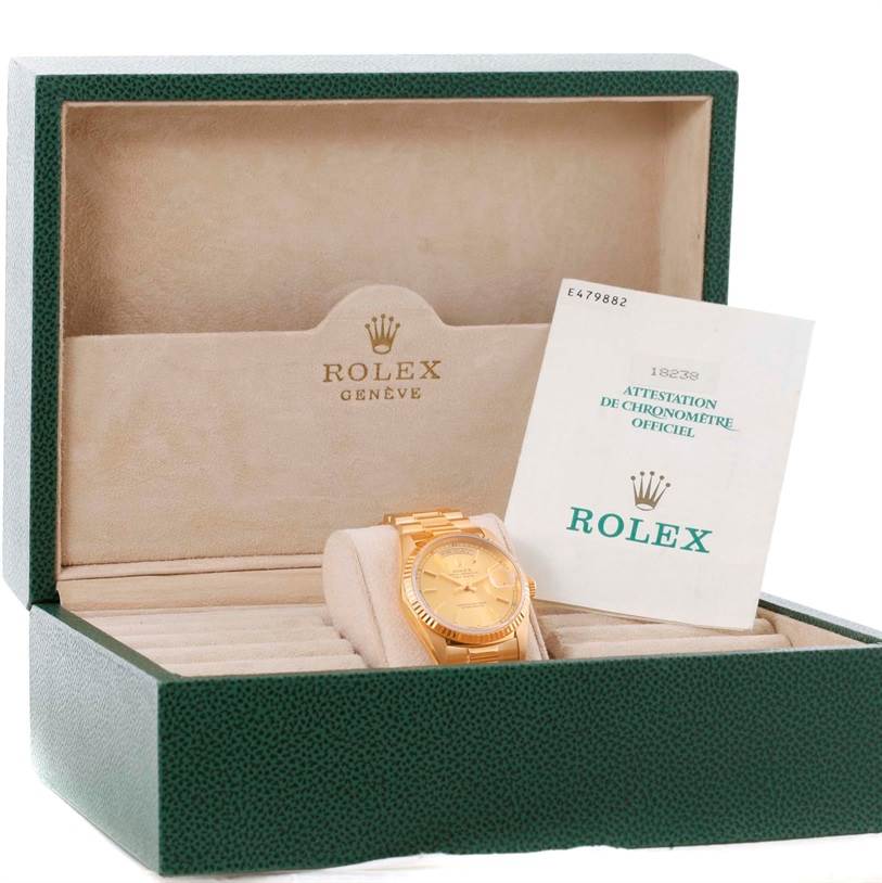 The Rolex President 18238 Men's Yellow Gold Champagne Dial 18238 Men's Yellow Gold Champagne Dial model watch is shown in its box along with its official chronometer certification.