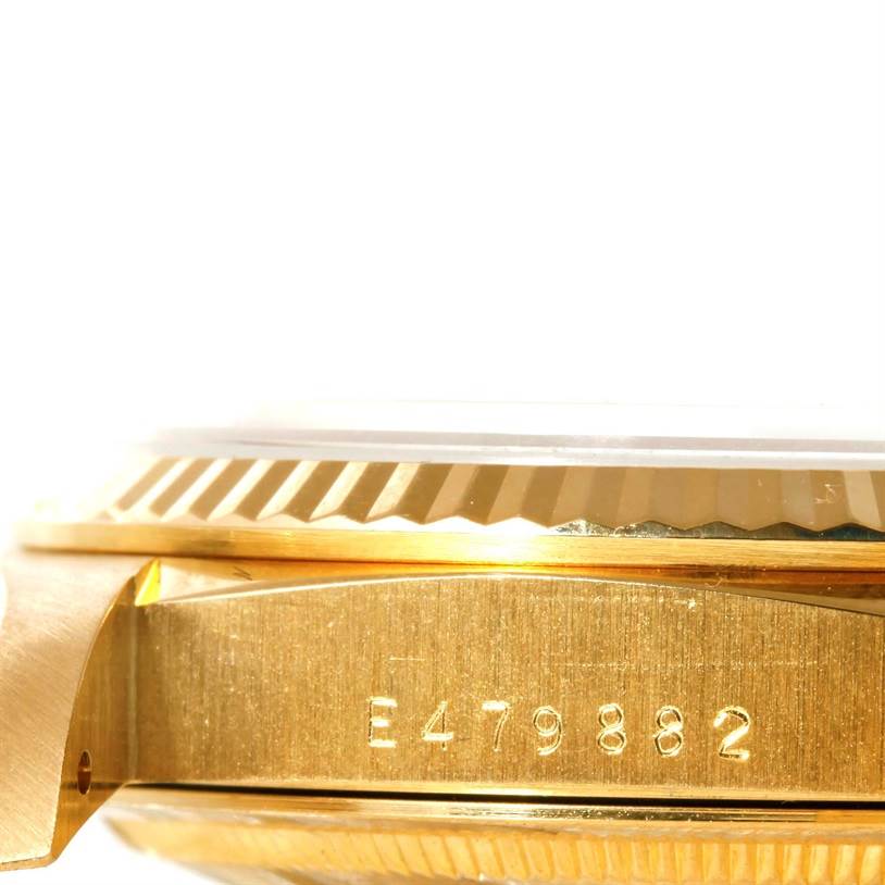 This image shows a close-up side view of the case and bezel of a Rolex President 18238 Men's Yellow Gold Champagne Dial 18238 Men's Yellow Gold Champagne Dial model, displaying its serial number.
