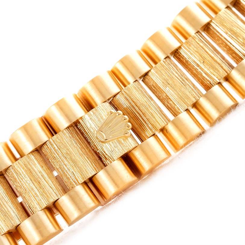 The image shows a close-up view of the gold bracelet of a Rolex President 18308 Men's Yellow Gold White Dial 18308 Men's Yellow Gold White Dial model watch, featuring the Rolex crown logo.