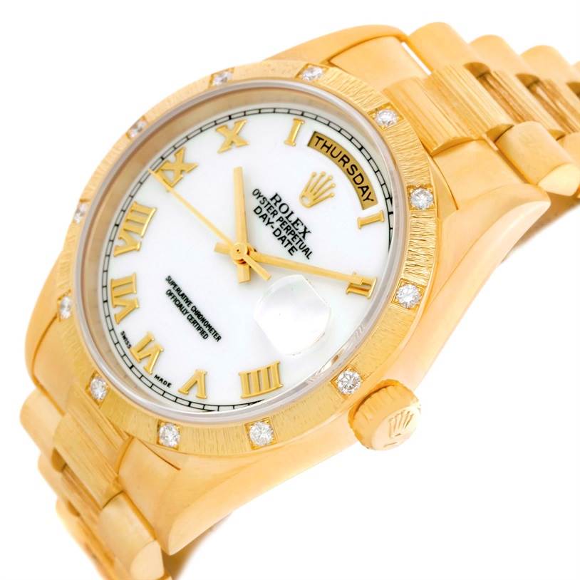 The image shows a top angle of a gold Rolex President 18308 Men's Yellow Gold White Dial 18308 Men's Yellow Gold White Dial watch, highlighting the dial, bezel, and part of the bracelet.