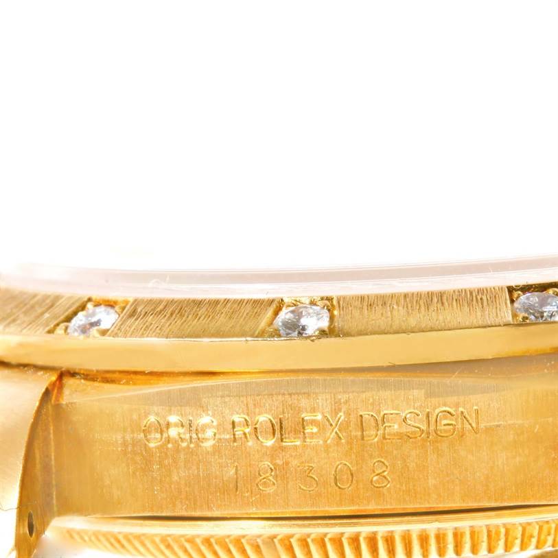 This image shows an angled close-up of the watch case and bezel of a Rolex President 18308 Men
s Yellow Gold Champagne Dial 18308 Men
s Yellow Gold Champagne Dial model, highlighting the "Orig Rolex Design" inscription and diamonds on the bezel.