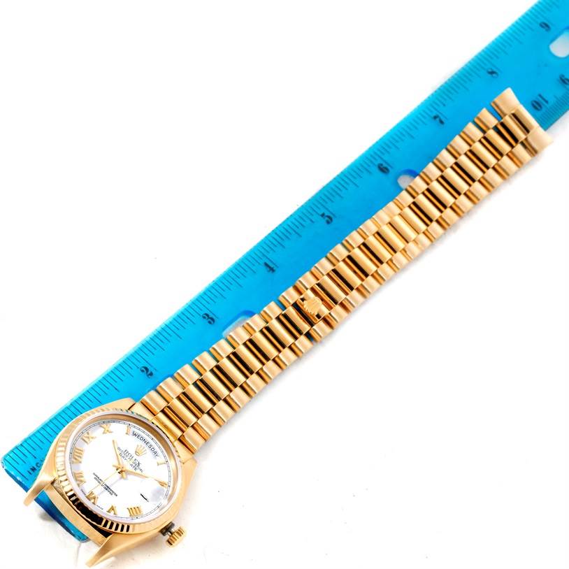 The image shows the entire President model by Rolex from a top-down angle, alongside a blue ruler.