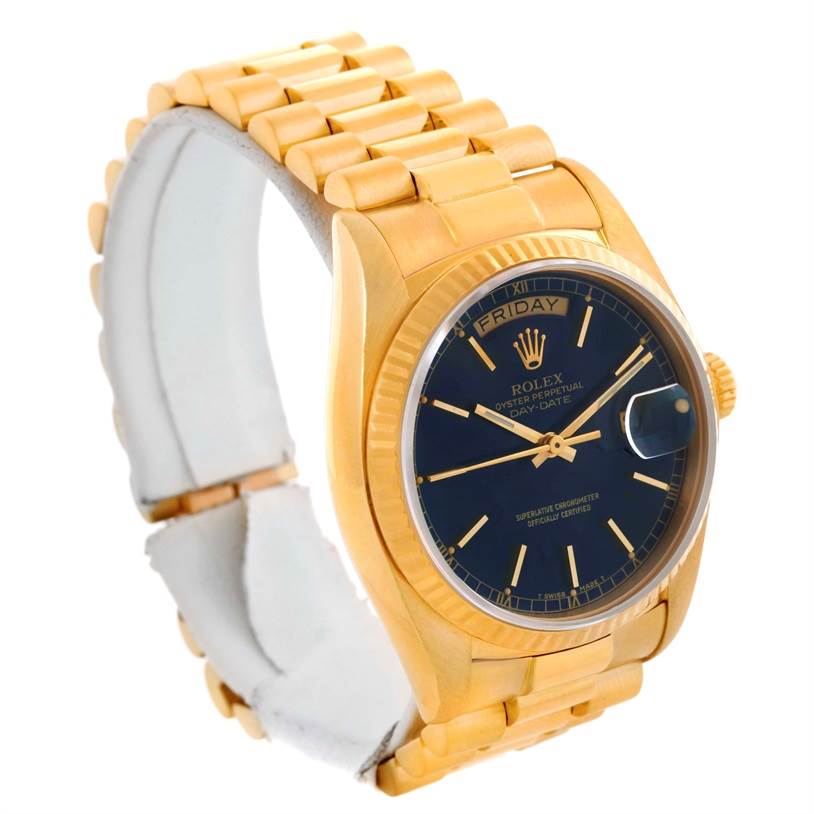 The image shows a Rolex President 18038 Men's Yellow Gold Blue Dial 18038 Men's Yellow Gold Blue Dial model watch with a gold bracelet, blue dial, and day-date display, angled to slightly show its right side.