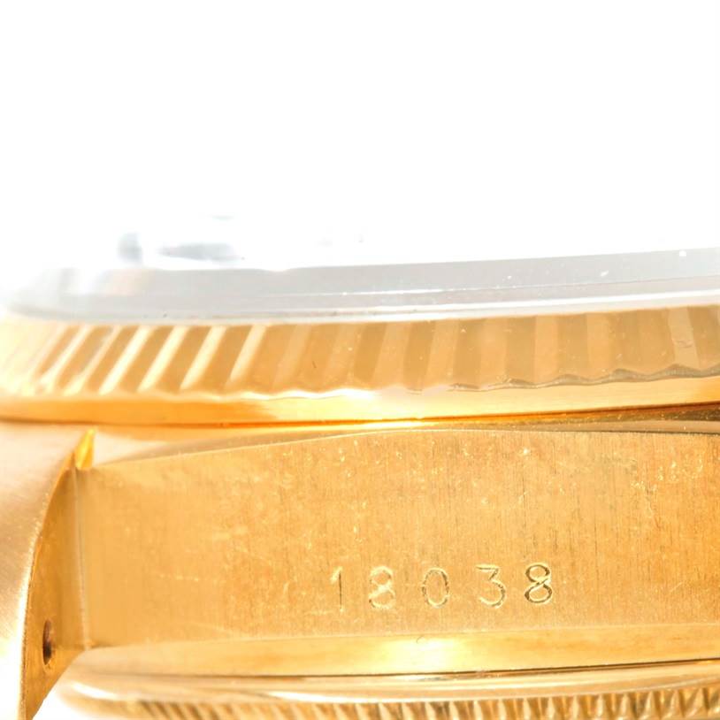 The image shows a side view of a Rolex President 18038 Men's Yellow Gold Blue Dial 18038 Men's Yellow Gold Blue Dial model watch, highlighting its fluted bezel and engraved model number 18038.