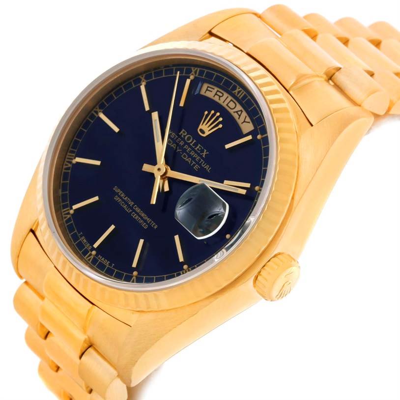 This Rolex President 18038 Men's Yellow Gold Blue Dial 18038 Men's Yellow Gold Blue Dial model watch is shown at an angle highlighting its gold bracelet, black dial, day-date window, and crown.
