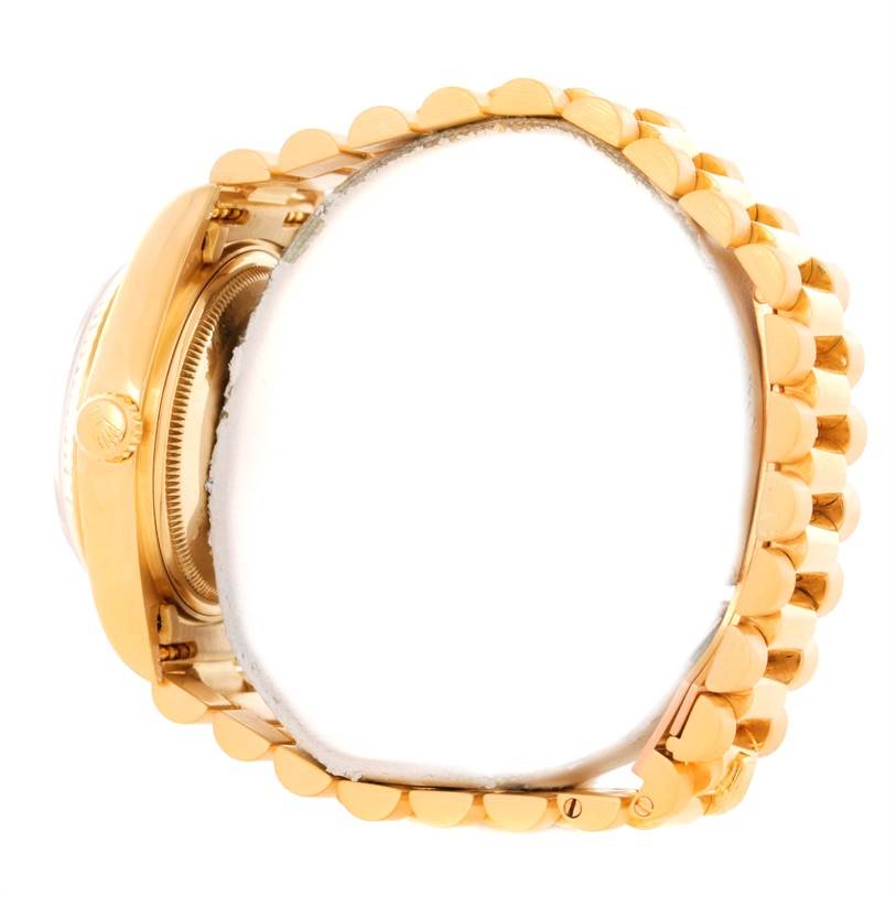 This side-view of the Rolex President 18038 Men's Yellow Gold Blue Dial 18038 Men's Yellow Gold Blue Dial watch shows the crown, case side, and bracelet links.