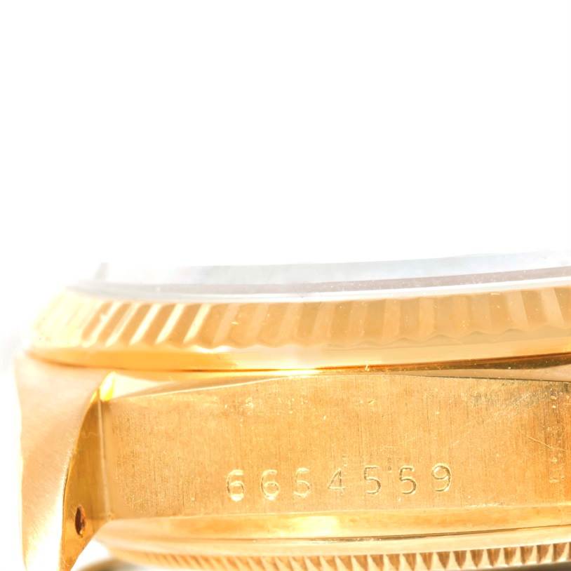 This image shows a close-up side view of the bezel and case of a Rolex President 18038 Men's Yellow Gold Blue Dial 18038 Men's Yellow Gold Blue Dial model watch.