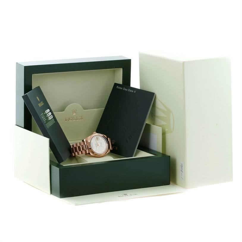 The Rolex President 218235 Men's Rose Gold Beige Dial 218235 Men's Rose Gold Beige Dial model watch and its accessories are shown in a box with instruction booklets.