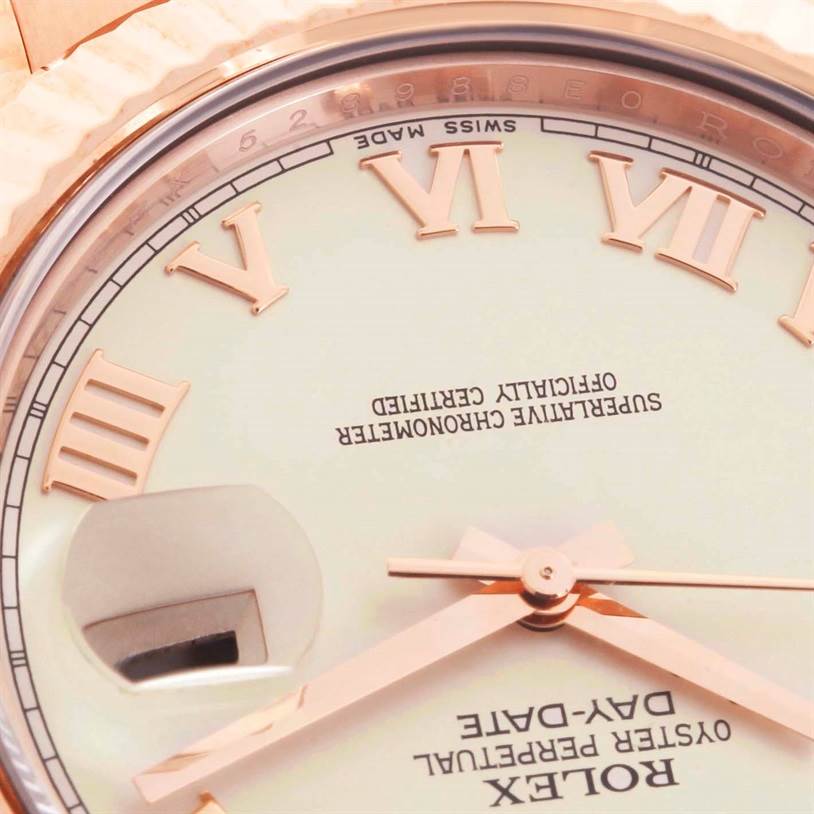 This close-up image of a Rolex President 218235 Men's Rose Gold Beige Dial 218235 Men's Rose Gold Beige Dial watch shows the dial, hands, Roman numeral markers, date magnification, and partial bezel.