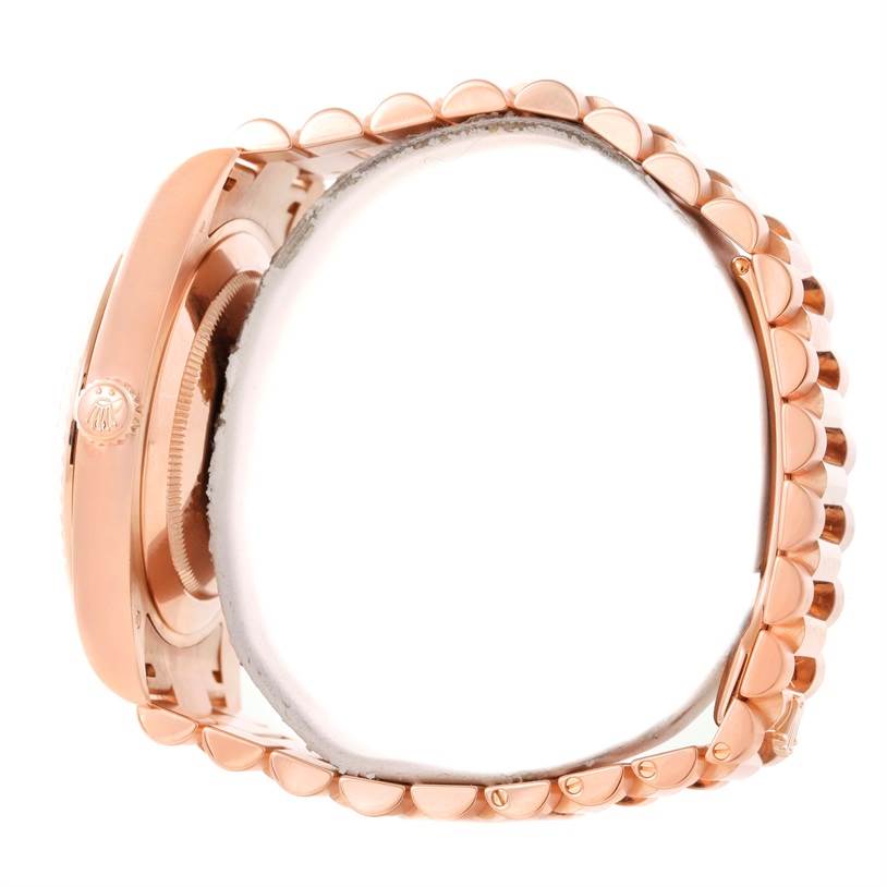 This side-view image of the Rolex President 218235 Men's Rose Gold Beige Dial 218235 Men's Rose Gold Beige Dial model watch shows the crown, case, and bracelet.