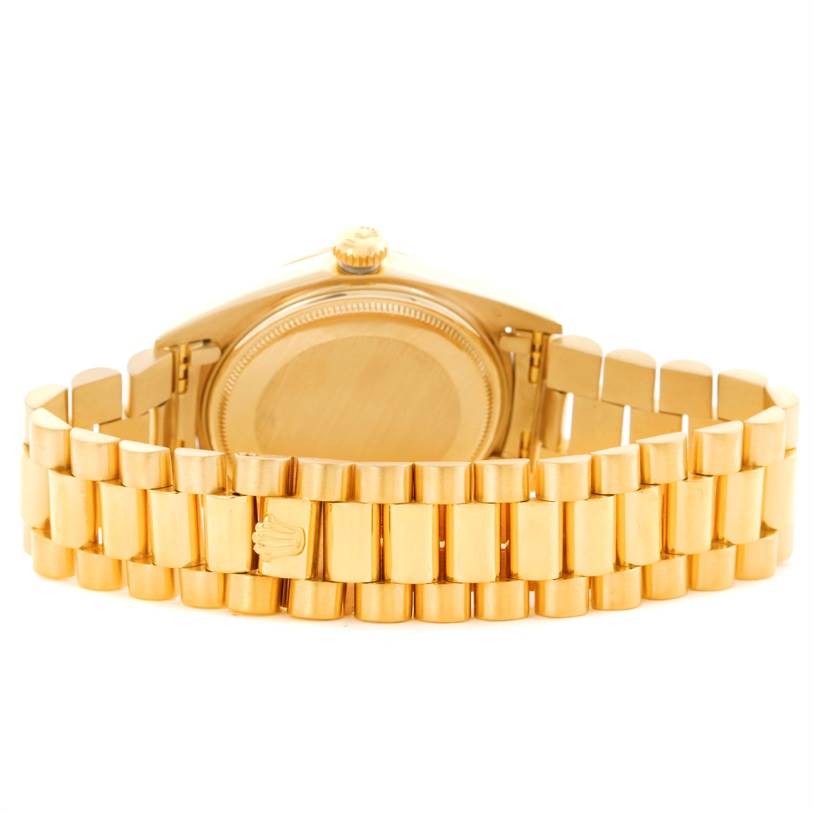 This image shows the back view of a Rolex President 1803 Men
s Yellow Gold Champagne Dial 1803 Men
s Yellow Gold Champagne Dial watch, highlighting its gold bracelet and case back.