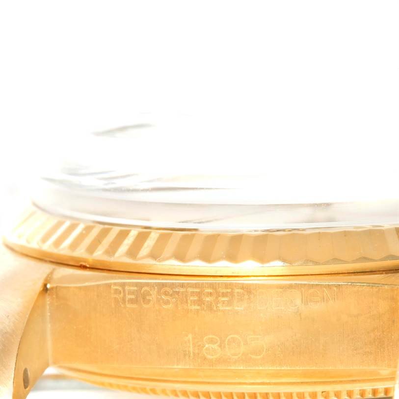 This image shows a close-up of the case side and bezel of a Rolex President 1803 Men
s Yellow Gold Champagne Dial 1803 Men
s Yellow Gold Champagne Dial model watch, displaying the watch
s registered design and model number.