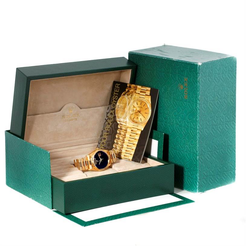The image shows a Rolex President 18238 Men
s Yellow Gold Champagne Dial 18238 Men
s Yellow Gold Champagne Dial model watch at an angle, displayed in an open box with accompanying booklets.