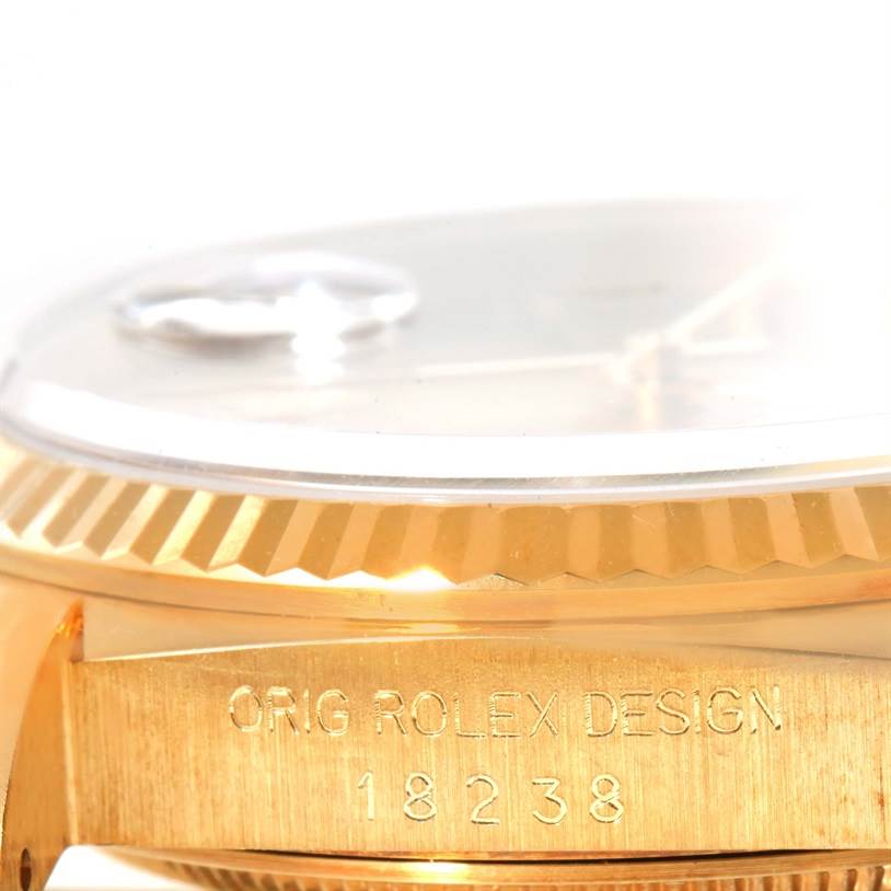 This image shows a close-up side view of the Rolex President 18238 Men
s Yellow Gold Champagne Dial 18238 Men
s Yellow Gold Champagne Dial model watch, highlighting the fluted bezel and engraved case.