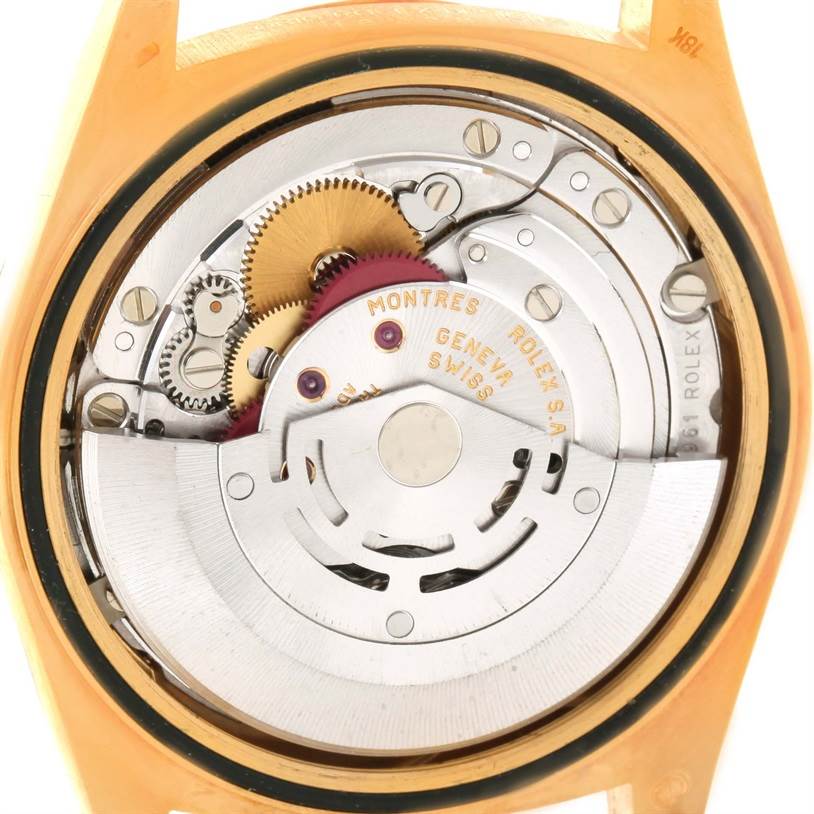 The image shows the internal mechanism of a Rolex President 18238 Men
s Yellow Gold Champagne Dial 18238 Men
s Yellow Gold Champagne Dial watch viewed from the back, highlighting its gears and movement parts.