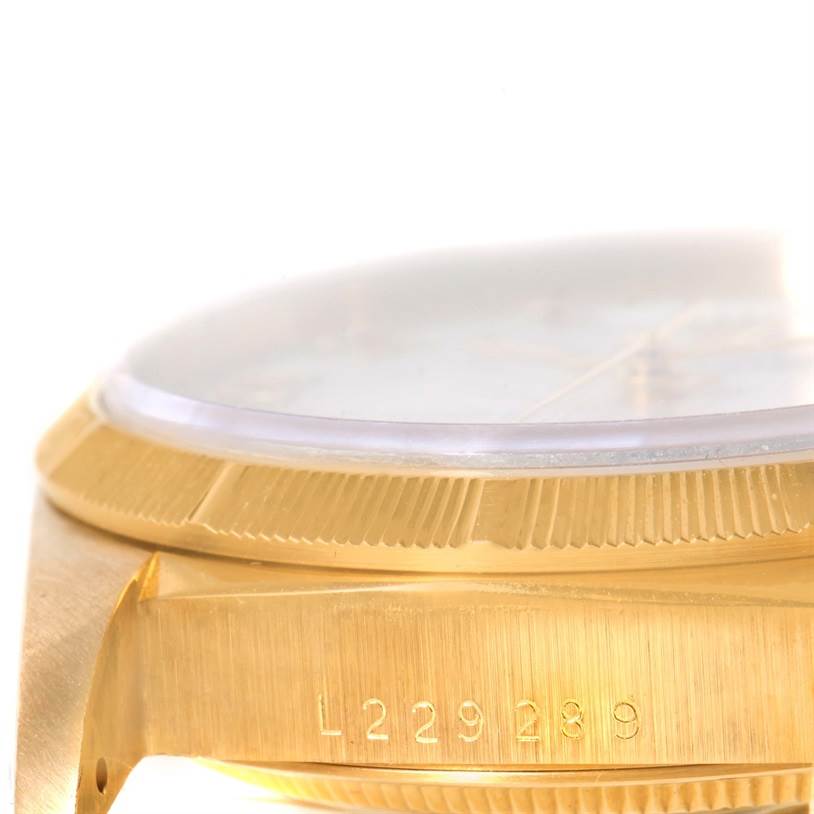 The image shows a close-up side angle of the Rolex President 18248 Men's Yellow Gold White Dial 18248 Men's Yellow Gold White Dial watch model, highlighting the bezel, crystal, and case with serial number.