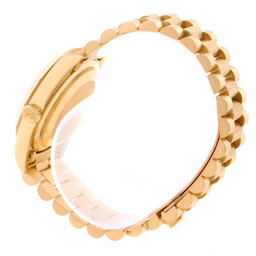 This image shows a side view of the Rolex President 18248 Men's Yellow Gold White Dial 18248 Men's Yellow Gold White Dial model, highlighting the crown, case, and part of the gold bracelet.