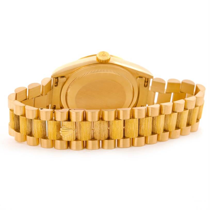 The image shows the back view of a Rolex President 18248 Men
s Yellow Gold Champagne Dial 18248 Men
s Yellow Gold Champagne Dial model watch, focusing on the case and the gold bracelet.