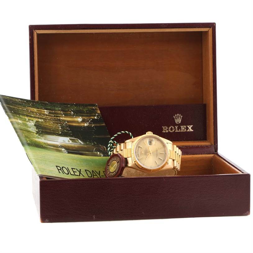 The Rolex President 18248 Men
s Yellow Gold Champagne Dial 18248 Men
s Yellow Gold Champagne Dial watch is displayed in an open wooden box, showing the face and bracelet of the watch along with a booklet.