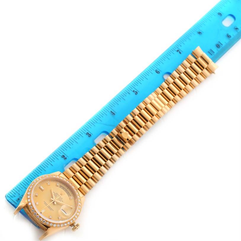The image shows a top view of a Rolex President 18348 Men
s Yellow Gold Champagne Dial 18348 Men
s Yellow Gold Champagne Dial watch with the bracelet measured by a ruler.