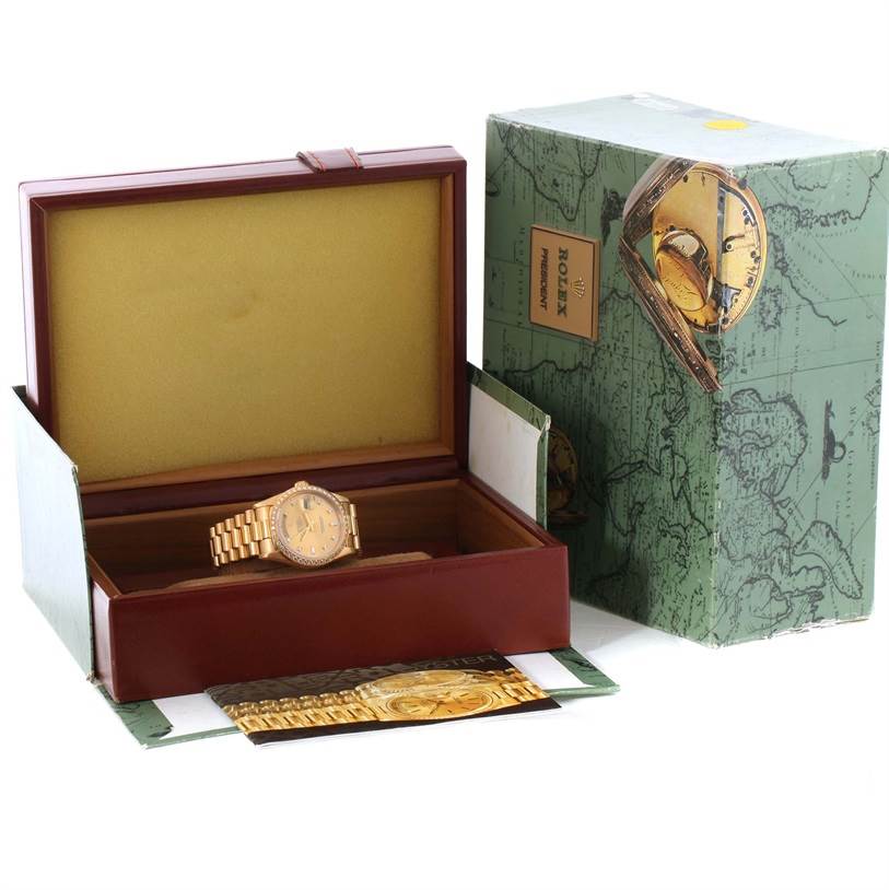 The image shows a Rolex President 18348 Men
s Yellow Gold Champagne Dial 18348 Men
s Yellow Gold Champagne Dial model watch with its open watch box and outer packaging, viewed from an angled perspective.