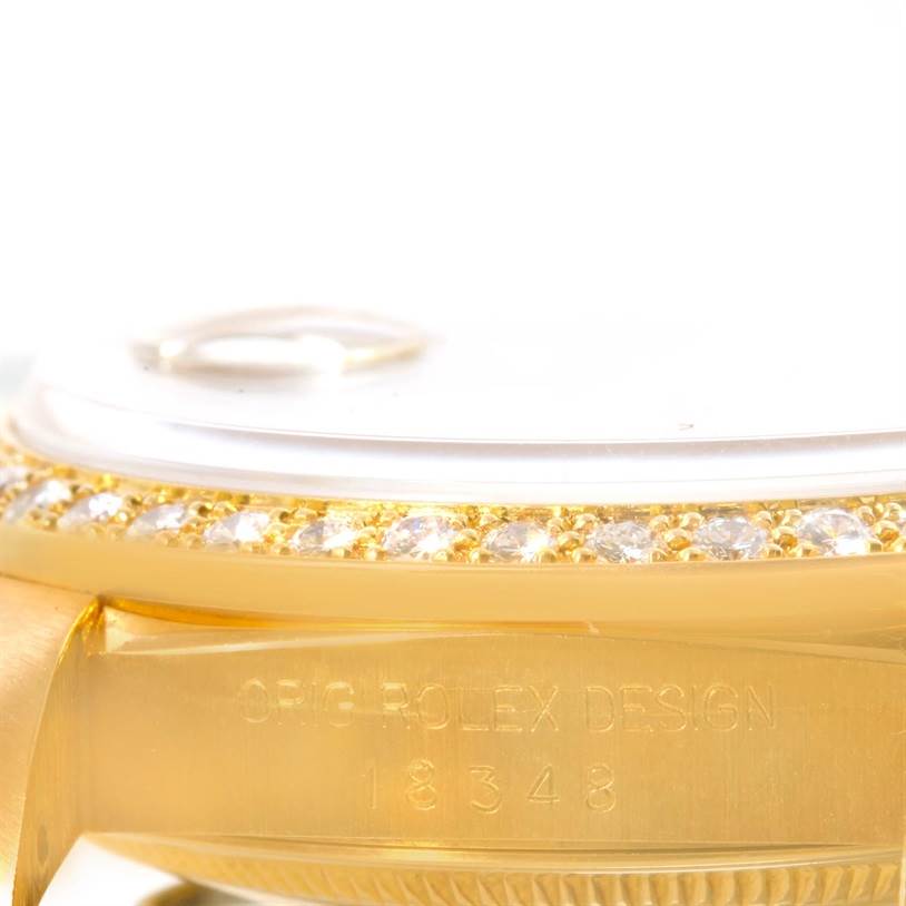 This close-up image of the Rolex President 18348 Men
s Yellow Gold Champagne Dial 18348 Men
s Yellow Gold Champagne Dial model shows the bezel, the serial number, and part of the case engraved with "ORIG. ROLEX DESIGN."
