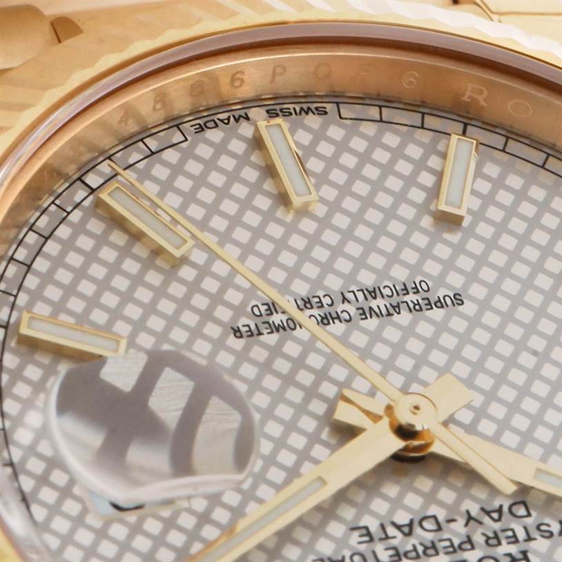 This close-up angle of the Rolex President 228238 Men's Yellow Gold Silver Dial 228238 Men's Yellow Gold Silver Dial model shows the dial, hour markers, hands, and date magnifier.