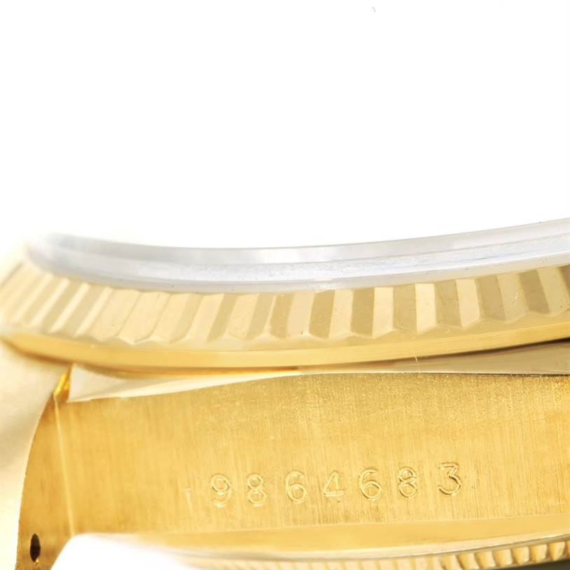 The image shows a close-up angle of the serial number and the fluted bezel of a Rolex President 18038 Men
s Yellow Gold Mother of Pearl Dial 18038 Men
s Yellow Gold Mother of Pearl Dial model watch.