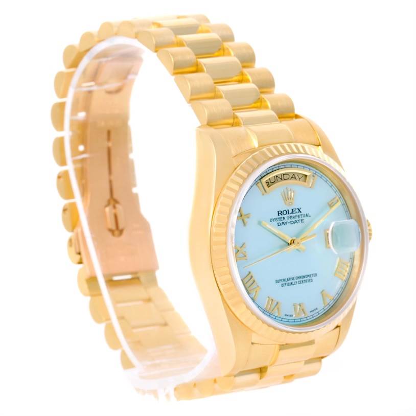 The image shows a side view of a Rolex President 18038 Men
s Yellow Gold Mother of Pearl Dial 18038 Men
s Yellow Gold Mother of Pearl Dial model watch, featuring a gold band, light blue dial, and day-date display.