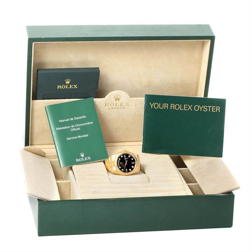The image shows a Rolex President 118238 Men
s Yellow Gold Black Dial 118238 Men
s Yellow Gold Black Dial model watch in its box, accompanied by warranty manuals and a Rolex Oyster booklet.