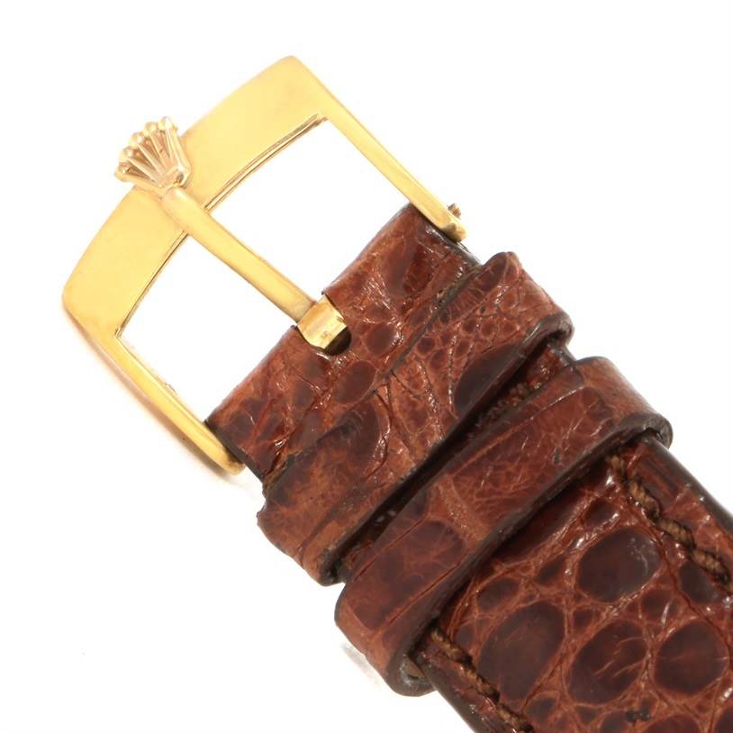 This image shows a close-up of a Rolex President 1803 Men
s Yellow Gold Silver Dial 1803 Men
s Yellow Gold Silver Dial model watch
s brown leather strap and gold buckle.