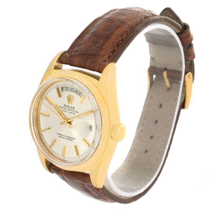 The Rolex President 1803 Men
s Yellow Gold Silver Dial 1803 Men
s Yellow Gold Silver Dial model watch is shown at a slight angle, highlighting its face, gold bezel, and brown leather strap.